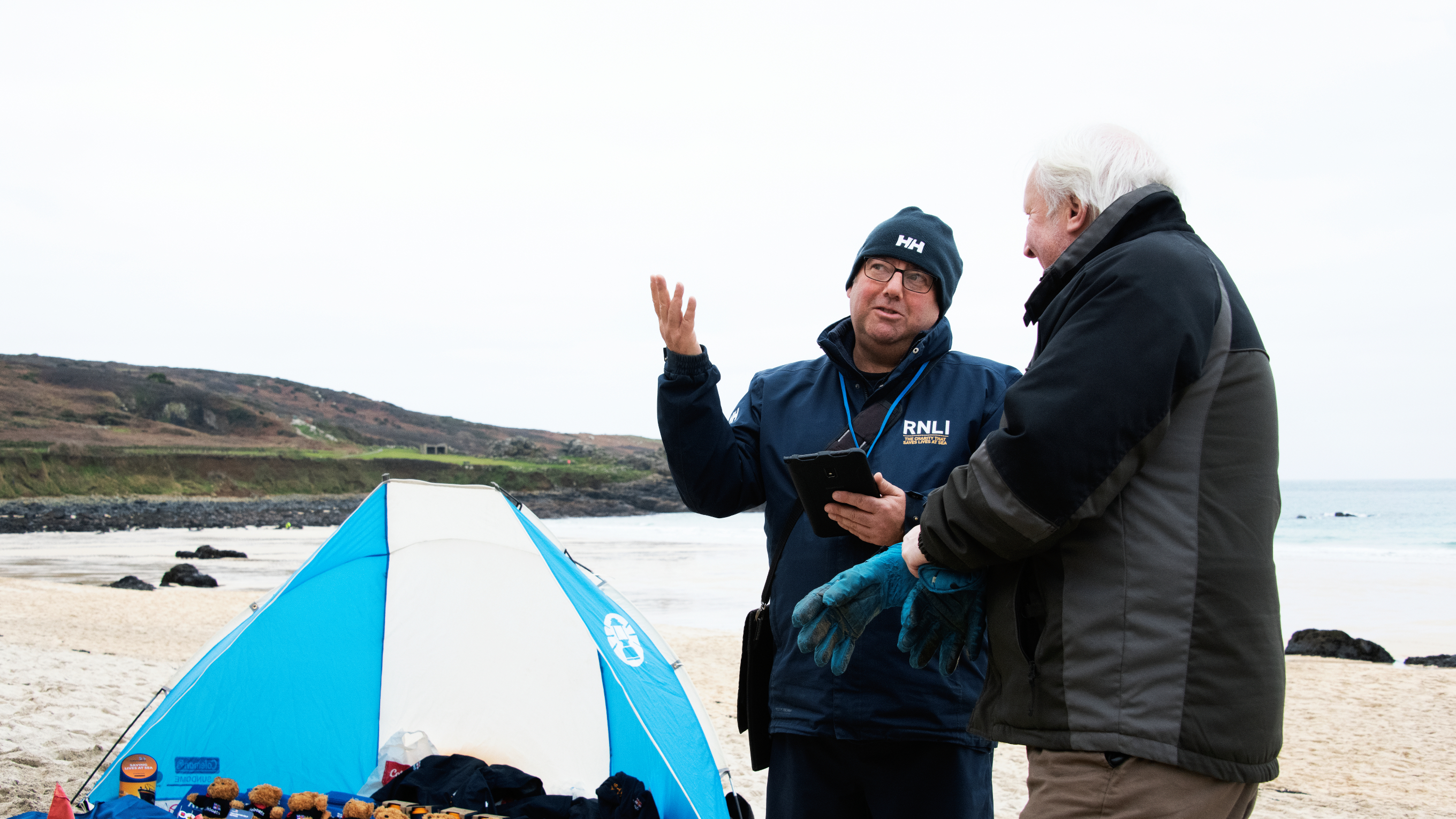 F2F fundraiser David Lilley talking to members of the public on Porthmeor beach, St Ives