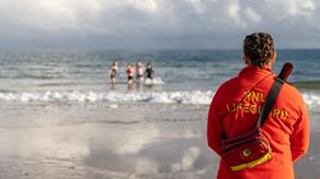 RNLI Lifeguards running on the beach